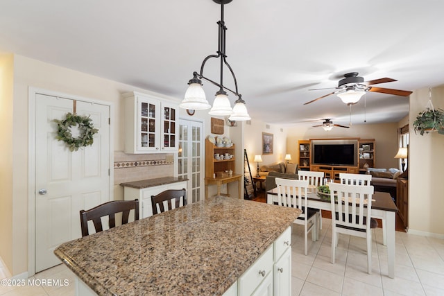 1102 Schencks Mill Line Rd, Toms River, NJ 08753 - kitchen with a ceiling fan, light tile patterned floors, a kitchen island, light stone countertops, and white cabinets