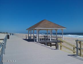 2005 Nassau Dr, Spring Lake, NJ 07762 - dock featuring a gazebo, view of water and beach, and a pier