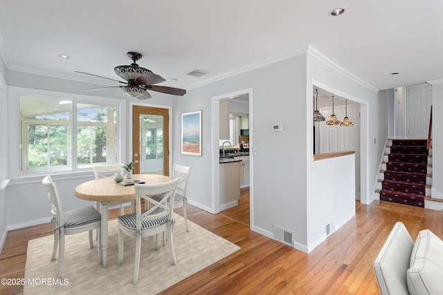2005 Nassau Dr, Spring Lake, NJ 07762 - dining area with ornamental molding, a ceiling fan, light wood-style floors, stairs, and recessed lighting