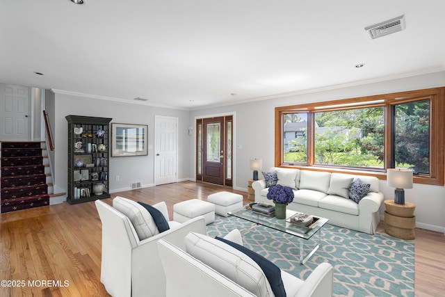 2005 Nassau Dr, Spring Lake, NJ 07762 - living area with plenty of natural light, stairway, light wood-style floors, and ornamental molding