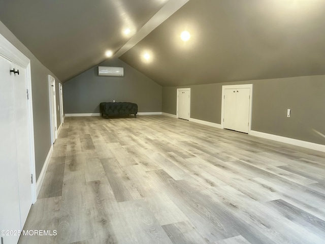 470 Mantoloking Rd, Brick, NJ 08723 - additional living space with a wall mounted air conditioner, light wood finished floors, lofted ceiling, and baseboards