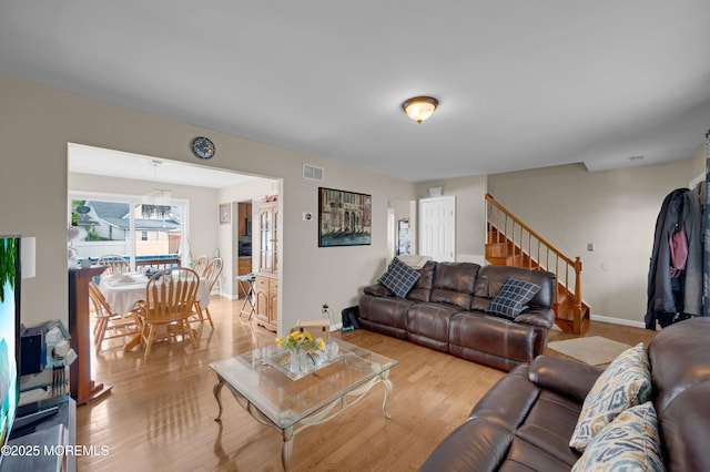 40 Wood St, Keansburg, NJ 07734 - living area with light wood-type flooring, a chandelier, stairway, and baseboards