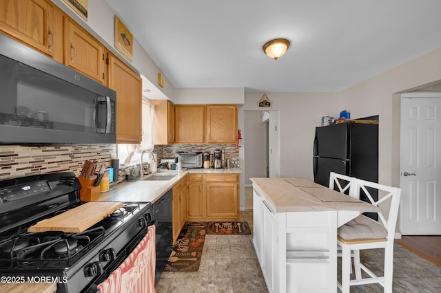 40 Wood St, Keansburg, NJ 07734 - kitchen featuring black appliances, a sink, light countertops, tasteful backsplash, and a breakfast bar area