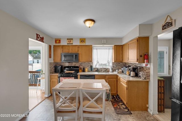40 Wood St, Keansburg, NJ 07734 - kitchen with gas range, healthy amount of natural light, backsplash, and light countertops