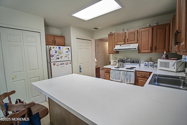 612 Petunia Ln S, Whiting, NJ 08759 - kitchen featuring exhaust hood, white appliances, a peninsula, a sink, and light countertops