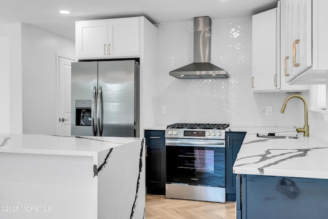 118 Cedar Point Ave, Brick, NJ 08723 - kitchen featuring wall chimney range hood, appliances with stainless steel finishes, a sink, tasteful backsplash, and white cabinetry