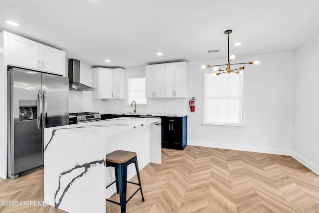 118 Cedar Point Ave, Brick, NJ 08723 - kitchen with wall chimney exhaust hood, appliances with stainless steel finishes, a chandelier, a center island, and white cabinets