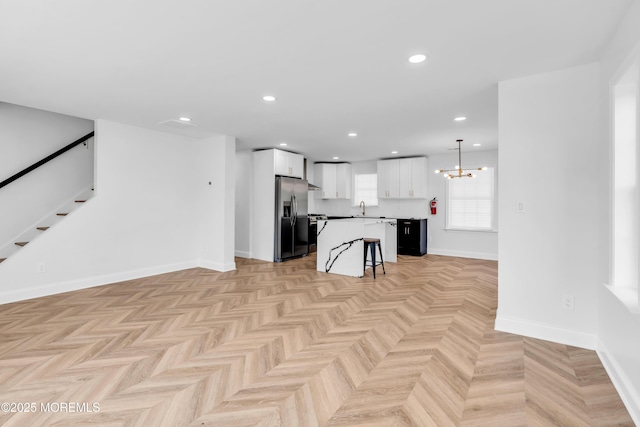 118 Cedar Point Ave, Brick, NJ 08723 - unfurnished living room featuring a sink, a chandelier, stairs, baseboards, and recessed lighting