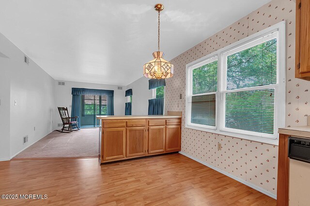 62 Woodshill Dr S, Lakewood, NJ 08701 - kitchen featuring wallpapered walls, light wood-type flooring, decorative light fixtures, light countertops, and a peninsula