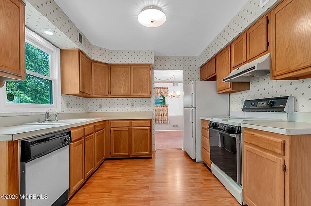 62 Woodshill Dr S, Lakewood, NJ 08701 - kitchen featuring range with electric cooktop, under cabinet range hood, dishwashing machine, a sink, and wallpapered walls