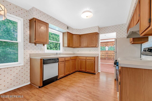 62 Woodshill Dr S, Lakewood, NJ 08701 - kitchen featuring wallpapered walls, dishwasher, range, light wood-type flooring, and light countertops