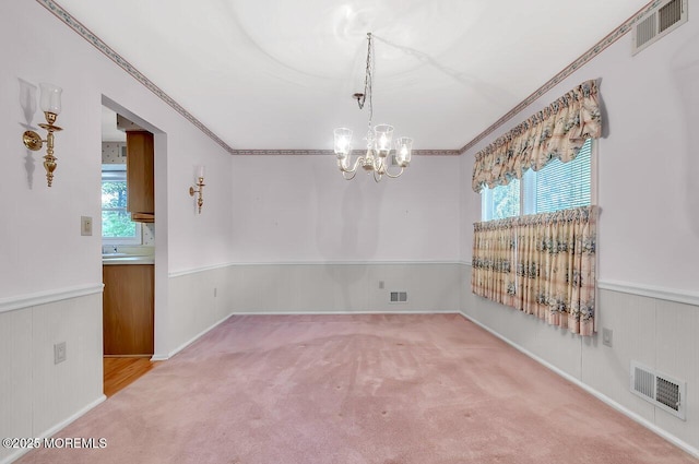 62 Woodshill Dr S, Lakewood, NJ 08701 - unfurnished room featuring a chandelier, a wainscoted wall, healthy amount of natural light, light colored carpet, and ornamental molding