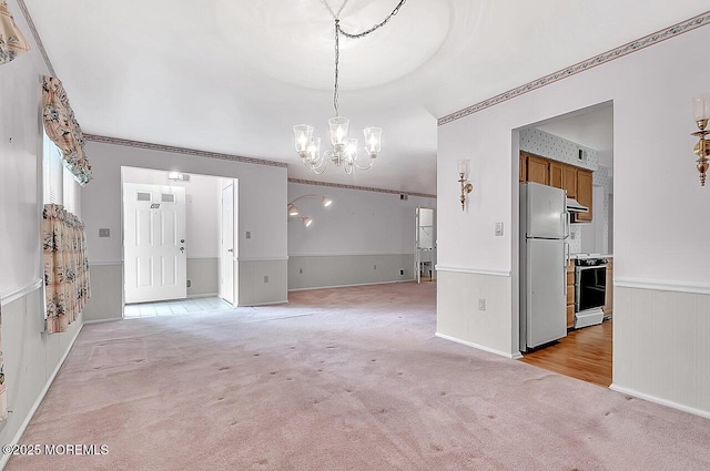 62 Woodshill Dr S, Lakewood, NJ 08701 - unfurnished living room featuring a chandelier, light carpet, and wainscoting