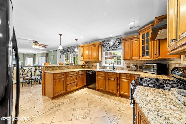 21 Tanglewood Pl, Monroe, NJ 08831 - kitchen featuring black appliances, premium range hood, a sink, brown cabinets, and a peninsula