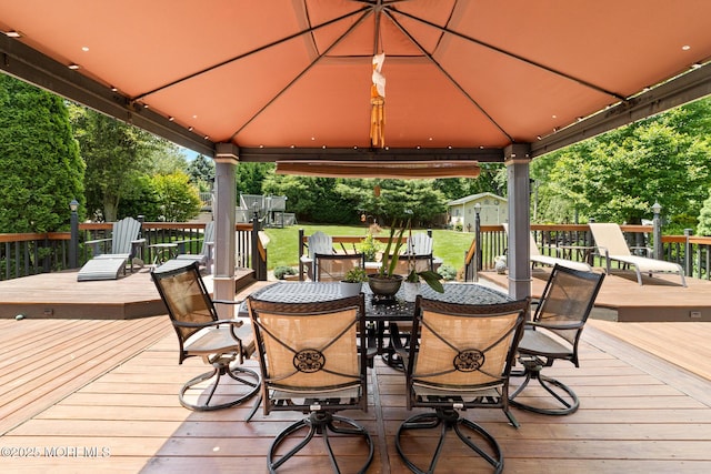 21 Tanglewood Pl, Monroe, NJ 08831 - wooden terrace with a gazebo, outdoor dining space, and a lawn