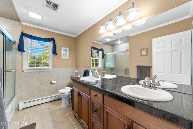 21 Tanglewood Pl, Monroe, NJ 08831 - full bathroom with a baseboard heating unit, tile patterned floors, double vanity, tile walls, and plenty of natural light