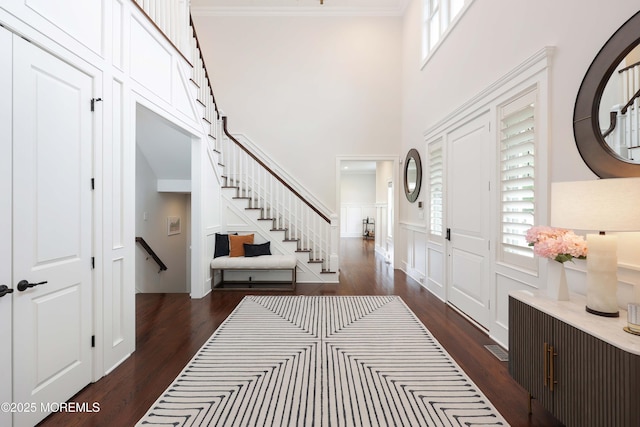 5 Buchop Ln, Red Bank, NJ 07701 - entrance foyer with dark wood-style flooring, stairs, wainscoting, and a towering ceiling