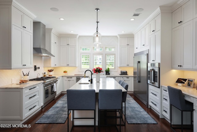 5 Buchop Ln, Red Bank, NJ 07701 - kitchen with premium appliances, wall chimney range hood, dark wood-style flooring, white cabinets, and a kitchen breakfast bar