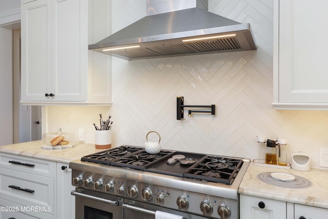 5 Buchop Ln, Red Bank, NJ 07701 - kitchen featuring range with two ovens, wall chimney exhaust hood, tasteful backsplash, white cabinets, and light stone counters