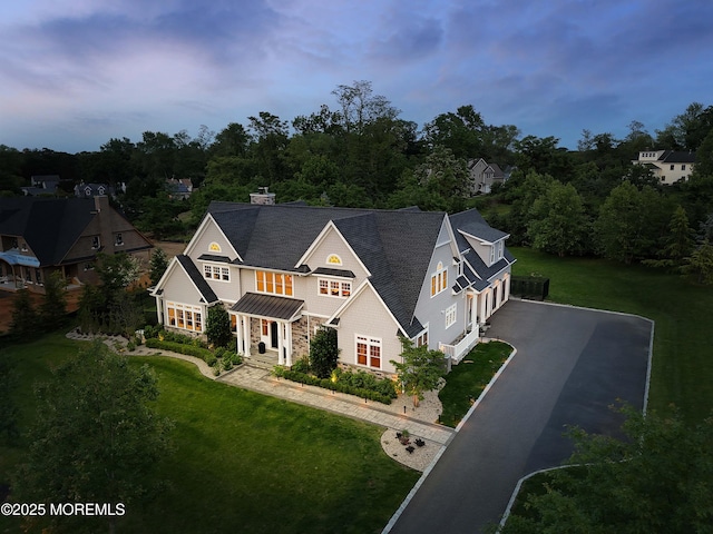 5 Buchop Ln, Red Bank, NJ 07701 - view of front of house with asphalt driveway, a lawn, a shingled roof, an attached garage, and stone siding
