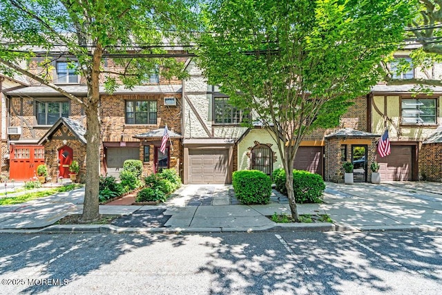 110A 56th St, West New York, NJ 07093 - view of front facade featuring brick siding and a garage