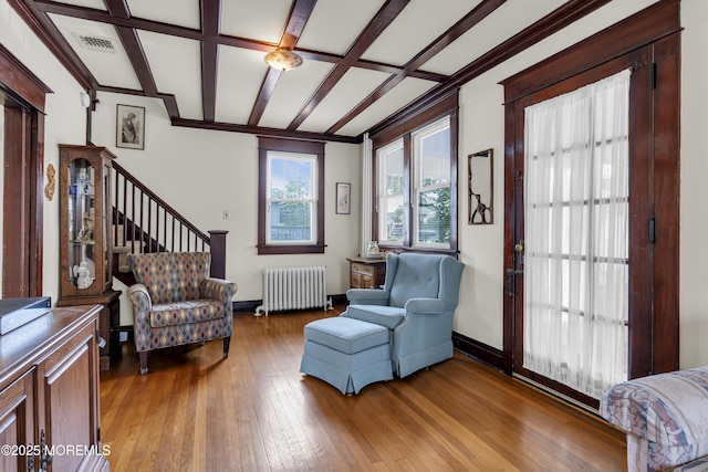 404 Saint Louis Ave, Point Pleasant Beach, NJ 08742 - living area featuring radiator heating unit, light wood-style flooring, coffered ceiling, and ornamental molding