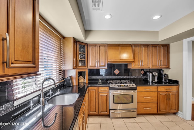 152 Redpine Loop, Old Bridge, NJ 08857 - kitchen with stainless steel gas stove, custom exhaust hood, a sink, brown cabinetry, and recessed lighting