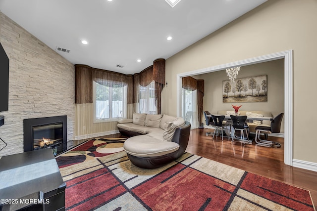152 Redpine Loop, Old Bridge, NJ 08857 - living area with vaulted ceiling, wood finished floors, a stone fireplace, baseboards, and recessed lighting