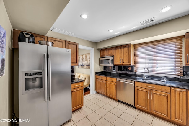 152 Redpine Loop, Old Bridge, NJ 08857 - kitchen with stainless steel appliances, a sink, brown cabinets, dark countertops, and recessed lighting