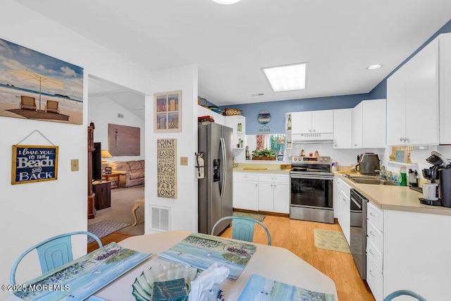 551 Petunia Ln N, Whiting, NJ 08759 - kitchen featuring appliances with stainless steel finishes, under cabinet range hood, light wood finished floors, light countertops, and white cabinetry