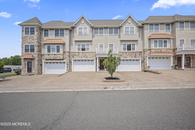 14 White Oak Ln, Aberdeen, NJ 07747 - townhome / multi-family property with stone siding, a standing seam roof, and driveway