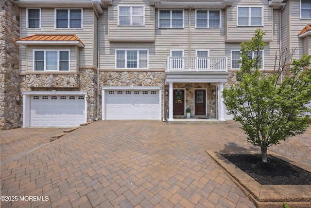 14 White Oak Ln, Aberdeen, NJ 07747 - townhome / multi-family property featuring stone siding, driveway, a garage, and a standing seam roof