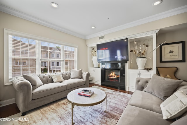 14 White Oak Ln, Aberdeen, NJ 07747 - living area with a warm lit fireplace, wood finished floors, ornamental molding, recessed lighting, and baseboards