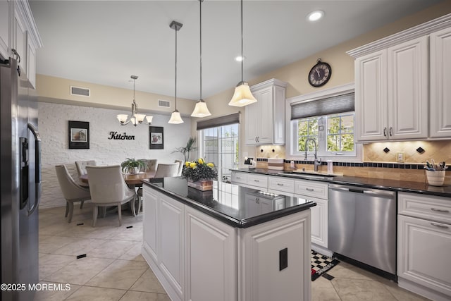 14 White Oak Ln, Aberdeen, NJ 07747 - kitchen with stainless steel appliances, dark countertops, a sink, a chandelier, and white cabinetry