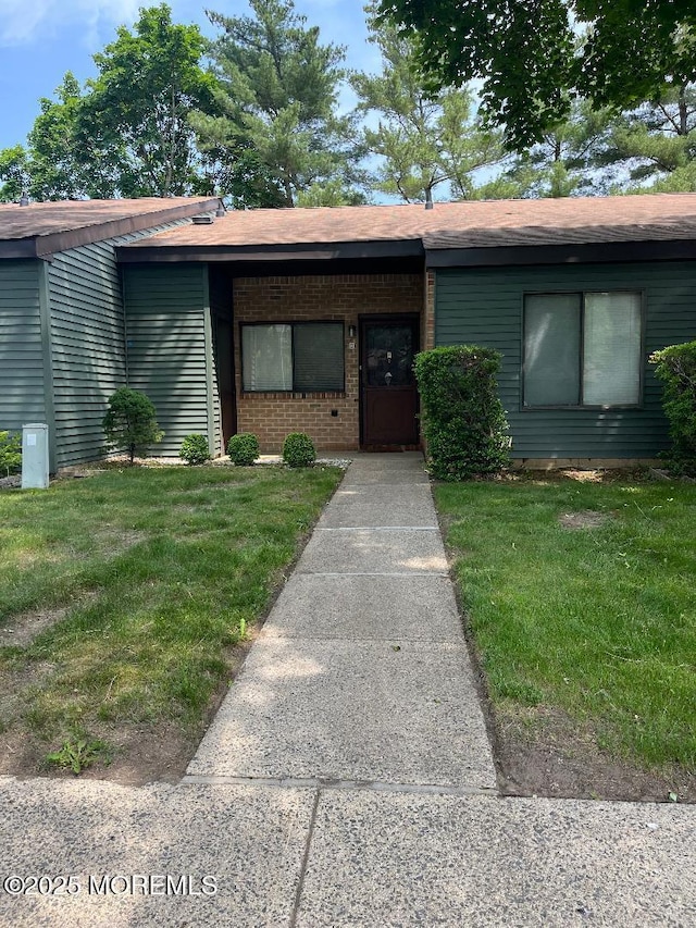 212 Covered Bridge Blvd Unit D, Manalapan, NJ 07726 - view of front facade featuring a front lawn and brick siding