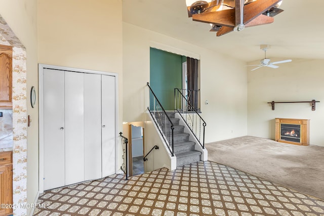 13 Copper Ln, Hazlet, NJ 07730 - interior space featuring carpet floors, a warm lit fireplace, a ceiling fan, and vaulted ceiling