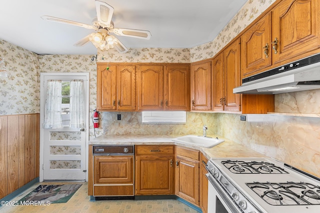 13 Copper Ln, Hazlet, NJ 07730 - kitchen featuring white gas range oven, under cabinet range hood, wallpapered walls, brown cabinets, and light countertops
