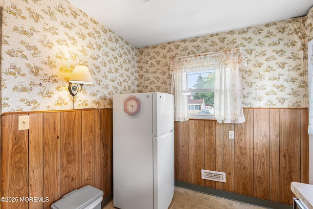 13 Copper Ln, Hazlet, NJ 07730 - kitchen featuring freestanding refrigerator, a wainscoted wall, wooden walls, wallpapered walls, and brown cabinetry