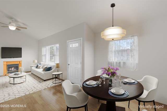 13 Copper Ln, Hazlet, NJ 07730 - dining area featuring a ceiling fan, vaulted ceiling, wood finished floors, and a glass covered fireplace