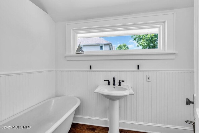 208 E Bergen Pl, Red Bank, NJ 07701 - full bath with a freestanding tub, wainscoting, lofted ceiling, and wood finished floors