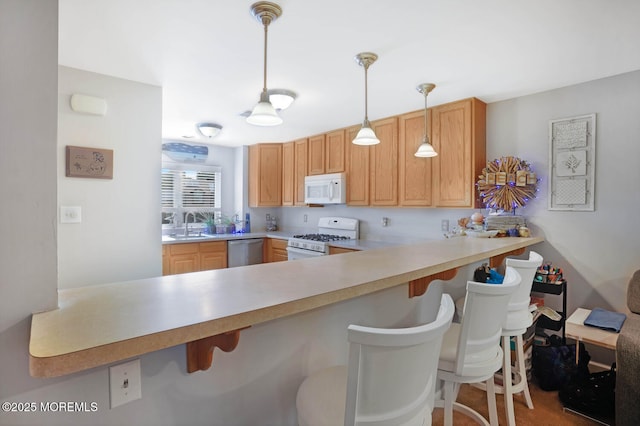 19 Corpus Cristi Bay Ct, Little Egg Harbor, NJ 08087 - kitchen featuring white appliances, a peninsula, a sink, pendant lighting, and light countertops