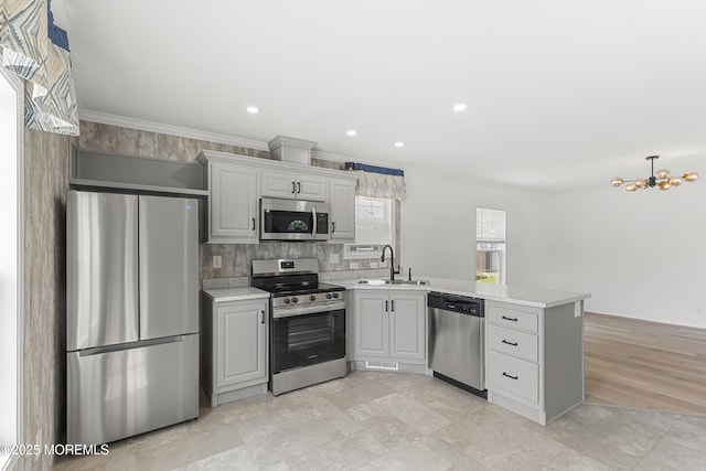 5 Pigeon Ct, Whiting, NJ 08759 - kitchen with appliances with stainless steel finishes, a sink, a peninsula, a chandelier, and crown molding