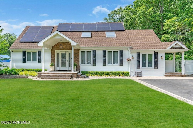 145 Docare Rd, Jackson, NJ 08527 - view of front of home featuring a front yard, roof with shingles, and solar panels