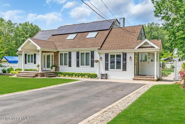 145 Docare Rd, Jackson, NJ 08527 - view of front of property featuring roof with shingles, a gate, a front lawn, roof mounted solar panels, and asphalt driveway