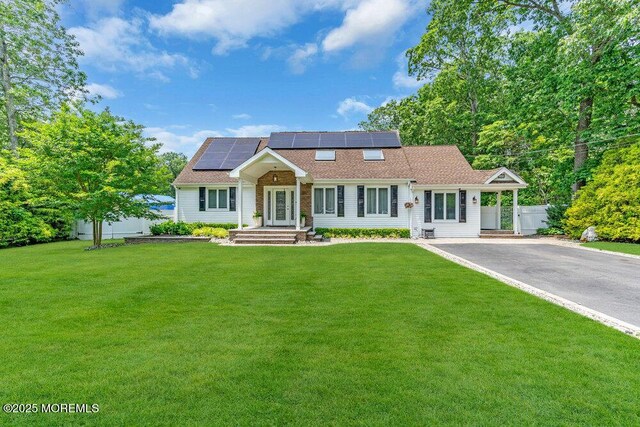 145 Docare Rd, Jackson, NJ 08527 - view of front of property with roof mounted solar panels, a front yard, asphalt driveway, and a shingled roof