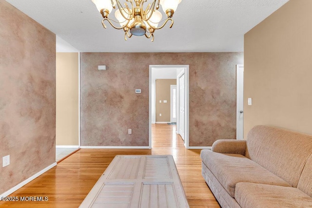 145 Docare Rd, Jackson, NJ 08527 - living room featuring light wood-type flooring, a chandelier, and baseboards