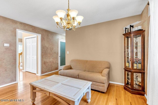 145 Docare Rd, Jackson, NJ 08527 - living room featuring a chandelier, light wood-type flooring, and baseboards