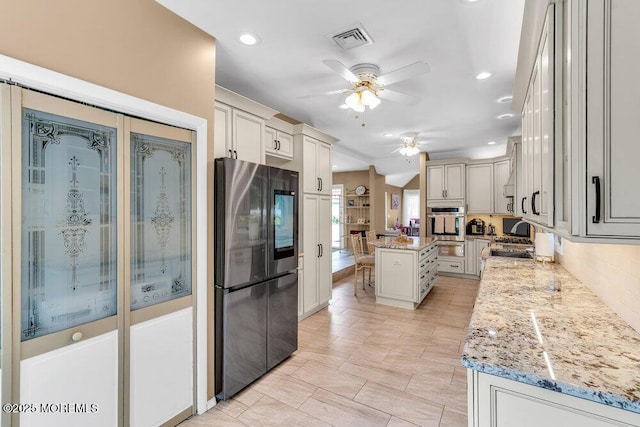 145 Docare Rd, Jackson, NJ 08527 - kitchen featuring appliances with stainless steel finishes, a ceiling fan, a kitchen island, light stone counters, and a warming drawer