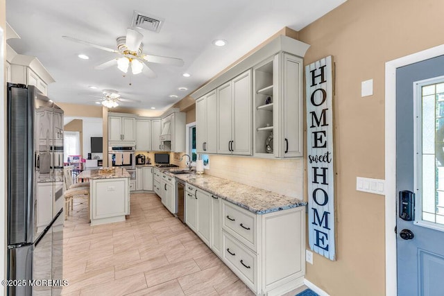 145 Docare Rd, Jackson, NJ 08527 - kitchen featuring stainless steel appliances, ceiling fan, tasteful backsplash, light stone counters, and recessed lighting