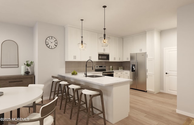 1403 N Kingsley St N Unit 213, Asbury Park, NJ 07712 - kitchen featuring stainless steel appliances, a sink, a peninsula, white cabinetry, and a breakfast bar area